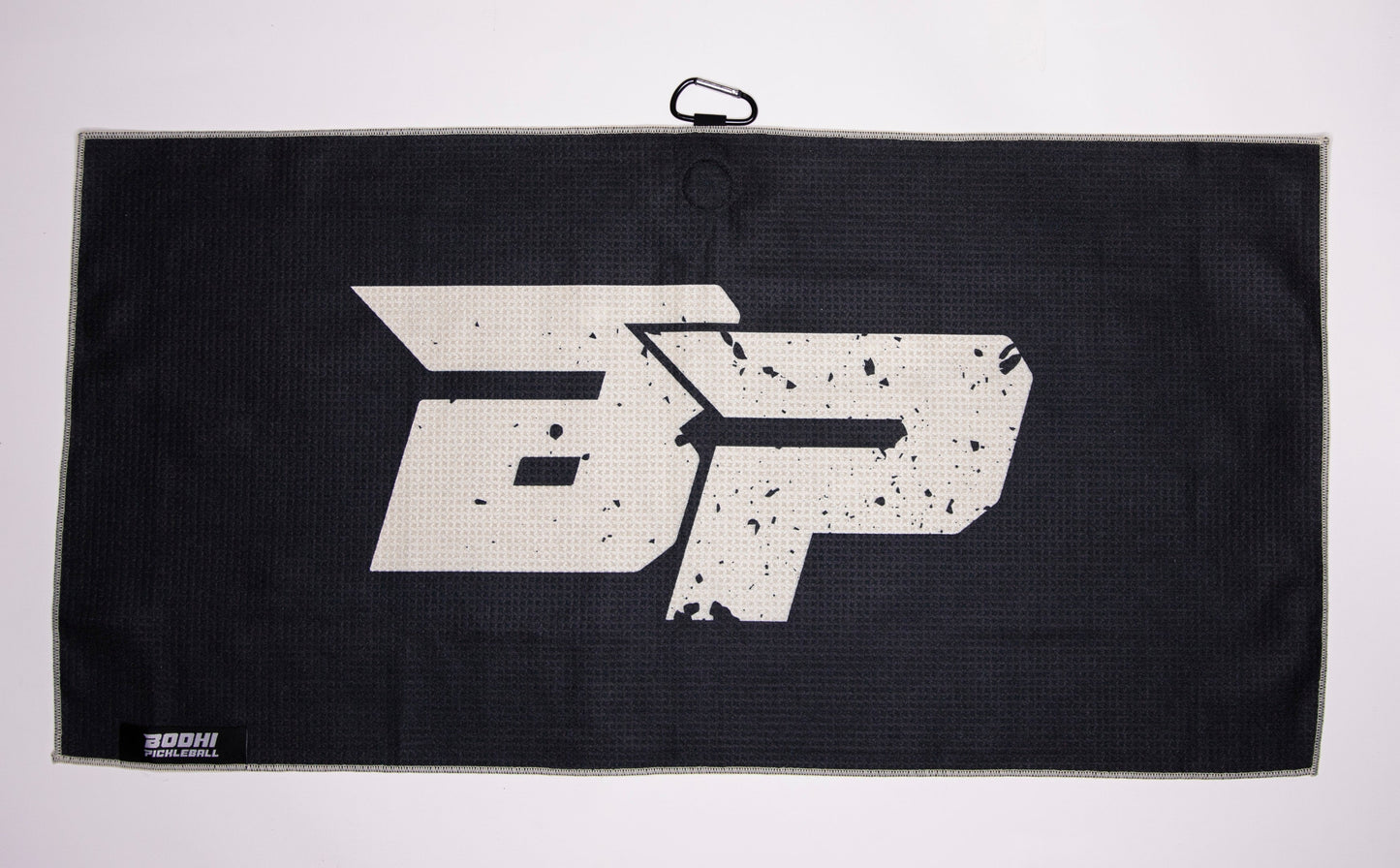 The Bodhi Performance Pickleball Towel is a rectangular black microfiber towel featuring a large distressed white DP logo, a top black carabiner clip, and a small white "BOHII" label—a must-have for pickleball accessories.