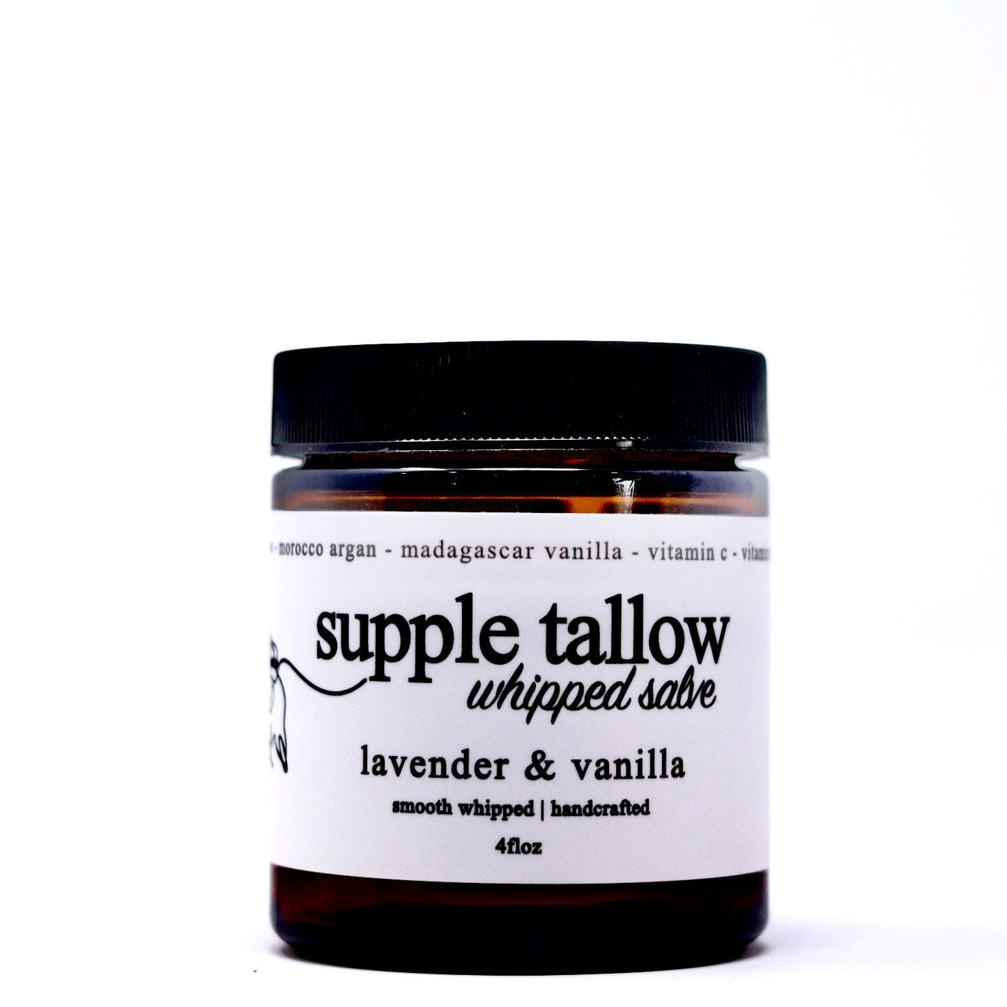 A brown glass jar with a black lid labeled "supple tallow salve" by Roots Apothecary. Its white label notes lavender & vanilla scent, grassfed tallow, Morocco argan, vitamins, smooth whipped texture, handcrafted organic skincare, 4 fl oz.