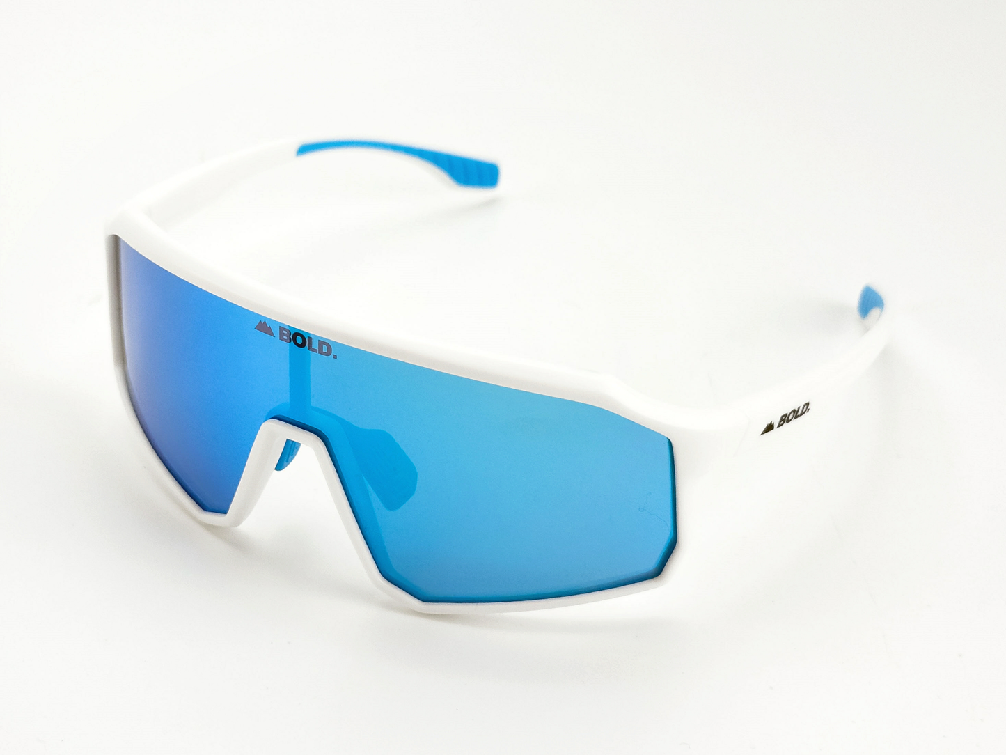 BOLD Rippers Kids Sunglasses by boldouterwear feature a thick white frame, large blue mirrored UV400 lenses, blue rubber-tipped arms, and "BOLD." printed on the lens. Perfect for MTB, ski & lifestyle. Set against a plain white background.