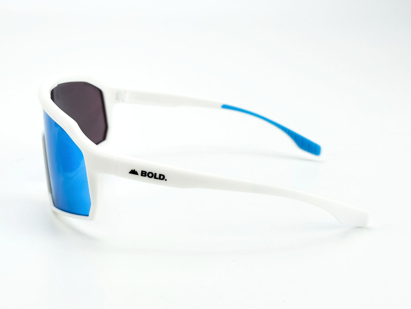 BOLD Rippers Kids Sunglasses by boldouterwear feature a white frame, blue-mirrored UV400 lenses, and blue-tipped arms. One arm displays “BOLD.” plus a mountain logo. Perfect for MTB, ski & lifestyle, shown on a clean background.