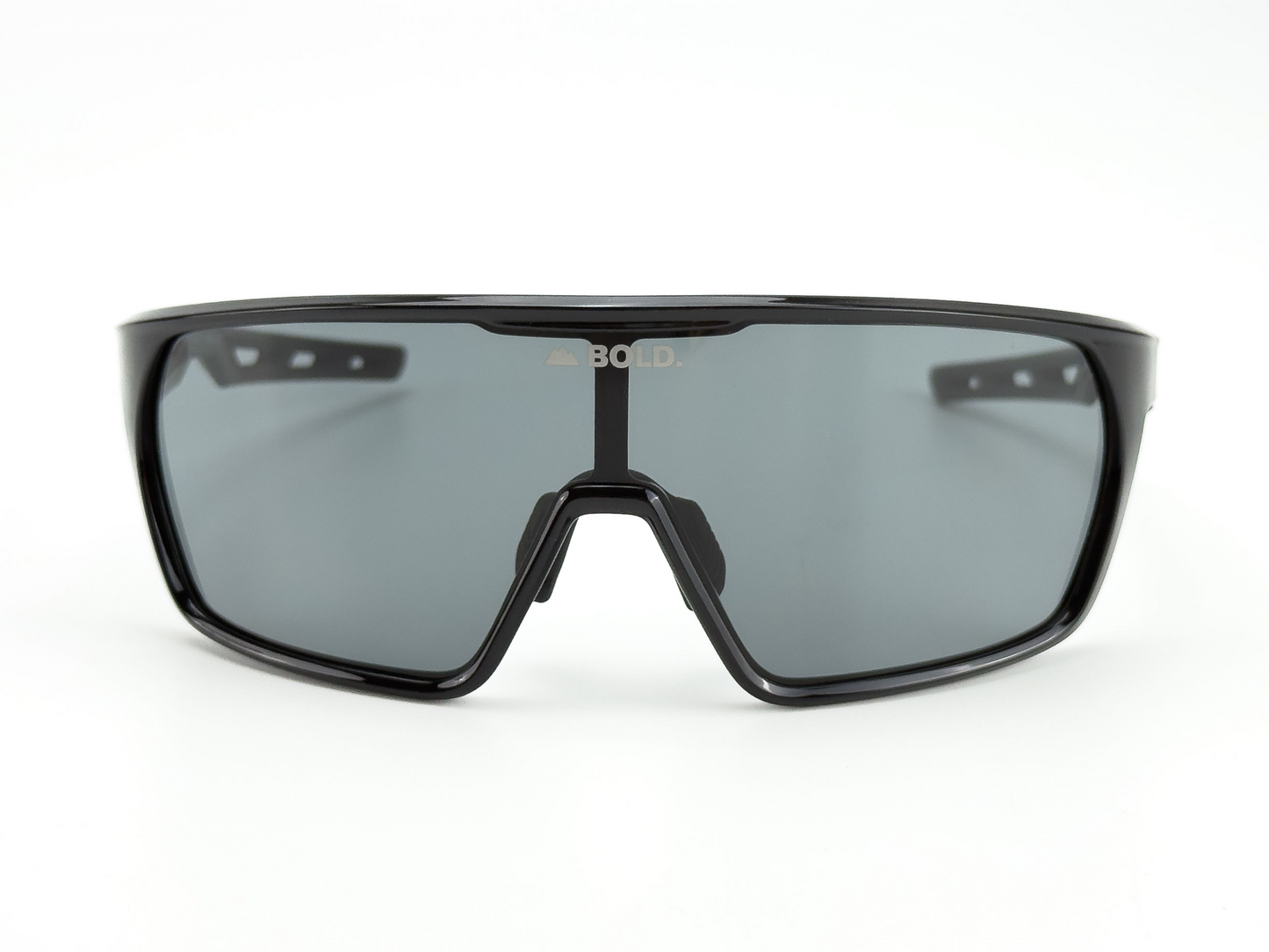 Front view of BOLD Senders Kids Sunglasses by boldouterwear, featuring a sporty wraparound black frame, dark tinted UV400 lenses, and "BOLD" with a mountain icon in white above the nose bridge—perfect for MTB, ski, and lifestyle wear.