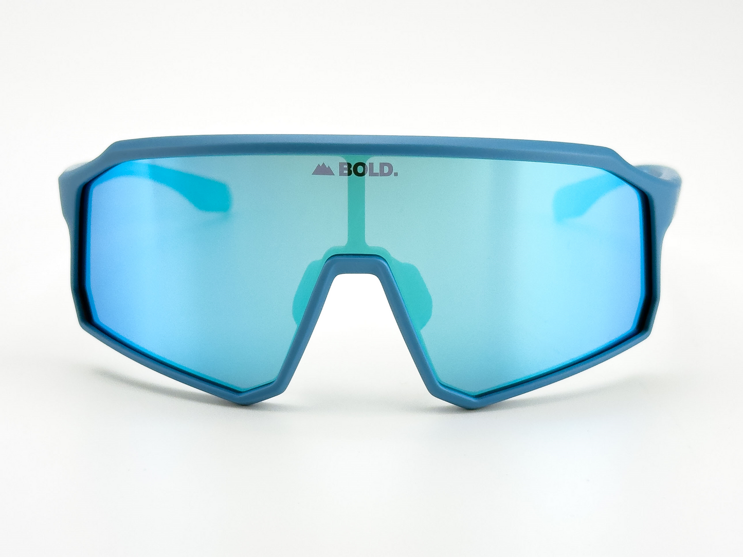 The BOLD Rippers Kids Sunglasses by boldouterwear feature a thick blue frame and a large, single mirrored green-blue UV400 lens with the “BOLD.” mountain logo at the top center. Perfect for MTB, ski, and everyday wear. White background.
