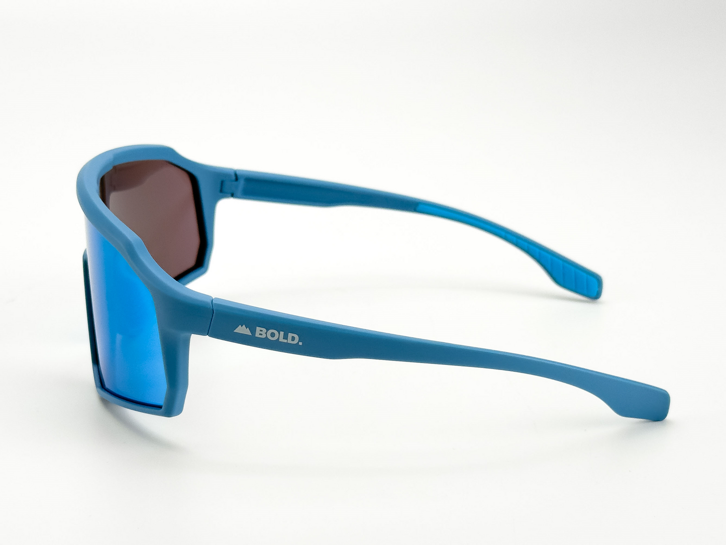 BOLD Rippers Kids Sunglasses from boldouterwear: blue sport shades with mirrored UV400 lenses and a mountain logo on the left arm, shown from the rear on white. Sleek, angular frames offer durability for MTB, ski & lifestyle use.