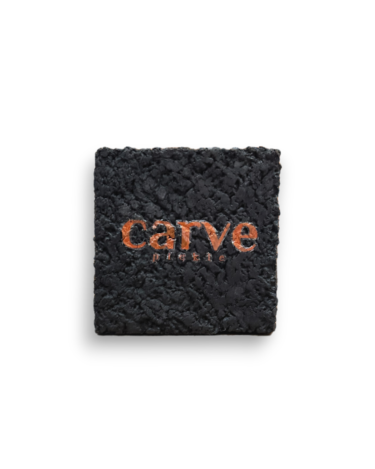 The Pickleball Paddle Eraser by Carve Sports features a textured black surface with “carve” cut out in the center, revealing an orange layer below for bold contrast against its clean design.