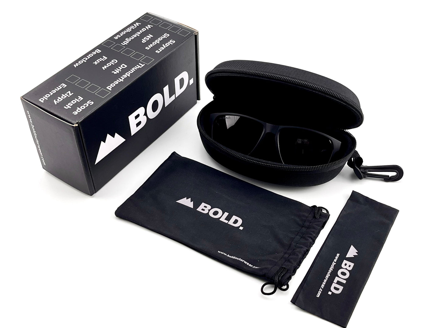 A pair of BOLD Thunderhead Performance Sunglasses from boldouterwear with fixed-tint lenses in a zippered hard case sits beside the box, drawstring pouch, and cleaning cloth—all with the boldouterwear logo on black fabric and packaging.