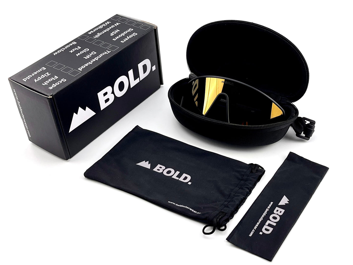 The BOLD NSP Performance Sunglasses by boldouterwear, sized for smaller faces with reflective gold lenses, are shown with a black zippered case, branded box, drawstring pouch, and cleaning cloth—all featuring the boldouterwear logo on a white background.