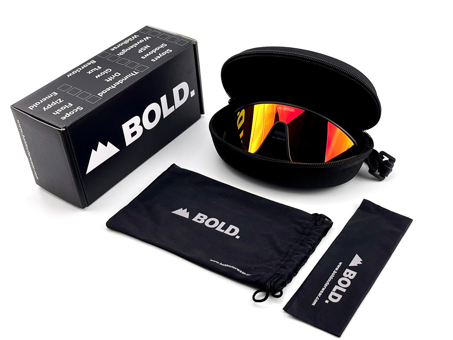 The BOLD NSP Performance Sunglasses by boldouterwear feature red-orange reflective wraparound lenses, shown with a black zippered case, drawstring pouch, cleaning cloth, and product box—each branded “BOLD.”—set against a white background.