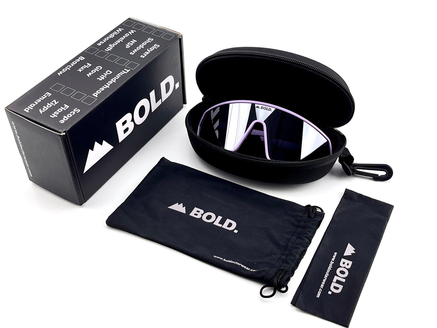 The BOLD NSP Performance Sunglasses by boldouterwear, featuring mirrored wraparound lenses, are displayed in a black hard case beside a branded box, microfiber pouch, and cleaning cloth—all arranged on a white background.