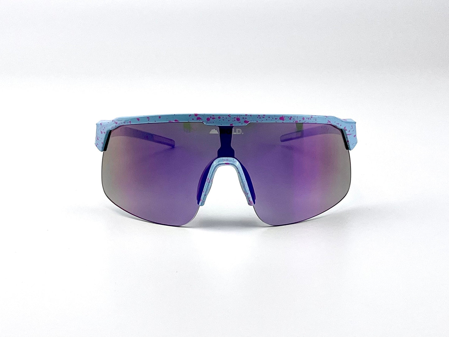 The BOLD Zippy Photochromic Sunglasses by boldouterwear feature a futuristic wraparound design with large purple-tinted lenses and a light blue frame with pink splatter patterns, perfect for MTB, ski, and lifestyle wear.