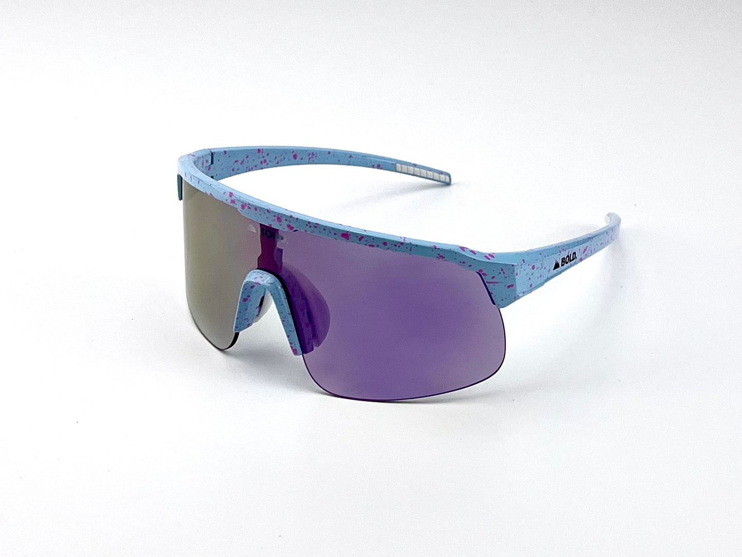 The BOLD Zippy Photochromic Sunglasses by boldouterwear feature a futuristic single wraparound purple lens and a light blue frame with pink splatter accents, offering angular style and comfort—perfect for MTB, ski, or lifestyle use.