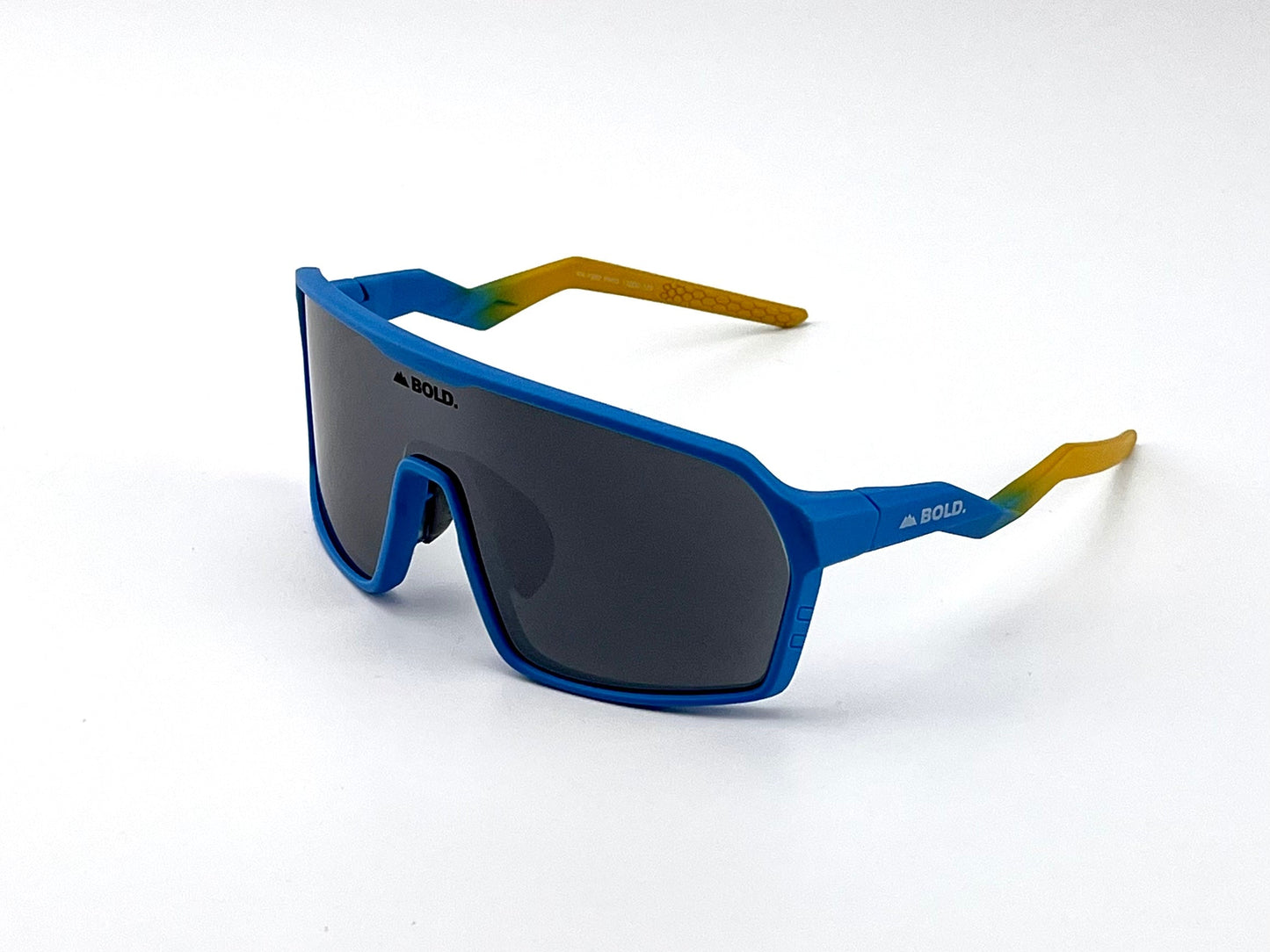 BOLD Glow Photochromic Sunglasses by boldouterwear feature blue frames, large rectangular lenses, and blue-to-yellow-green arms. The black "BOLD" logo is on the left lens and arms. Shown on a plain white background.