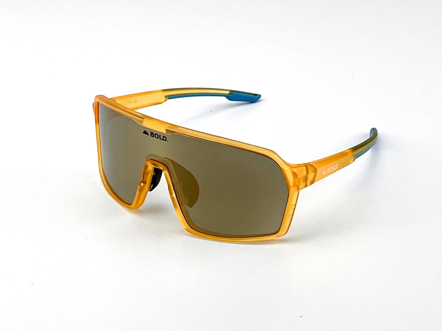 The BOLD Drift Photochromic Sunglasses by boldouterwear feature a large, single-piece brown lens and translucent orange frame with orange arms, blue tips, and "BOLD." in black on the lens and temple, shown against a white background.
