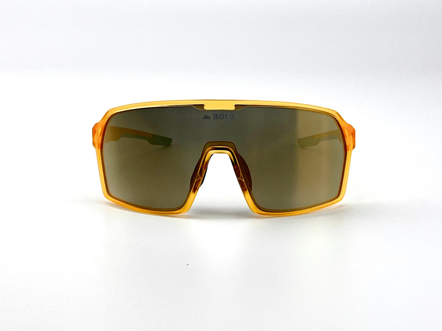 The BOLD Drift Photochromic Sunglasses by boldouterwear feature a thick translucent orange frame, large dark lenses, and a striking angular design. "BOLD" is printed at the top of the lens, perfect for MTB, ski, or lifestyle use.