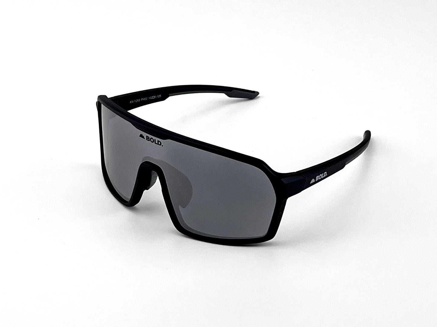A pair of black BOLD Drift Photochromic Sunglasses by boldouterwear, featuring an oversized design with a single dark lens and thick frame, brand name on lens and arm. Set against a plain white background.