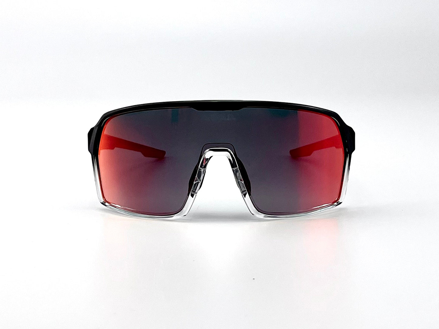 The BOLD Drift Photochromic Sunglasses by boldouterwear feature a single, wide red-tinted mirrored lens, a black upper frame, and clear lower edges for a sporty, minimal look perfect for MTB, ski, and lifestyle wear.