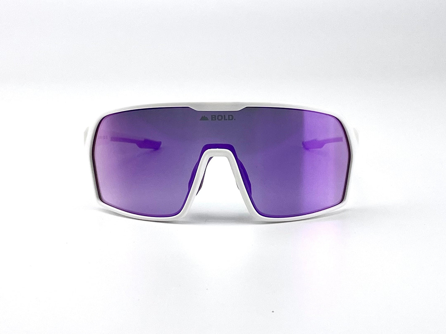 The boldouterwear BOLD Drift Photochromic Sunglasses feature a sporty white frame and large, single-piece purple reflective lens with “BOLD.” printed at the top center, shown on a plain white background. Perfect for MTB, ski, and lifestyle wear.