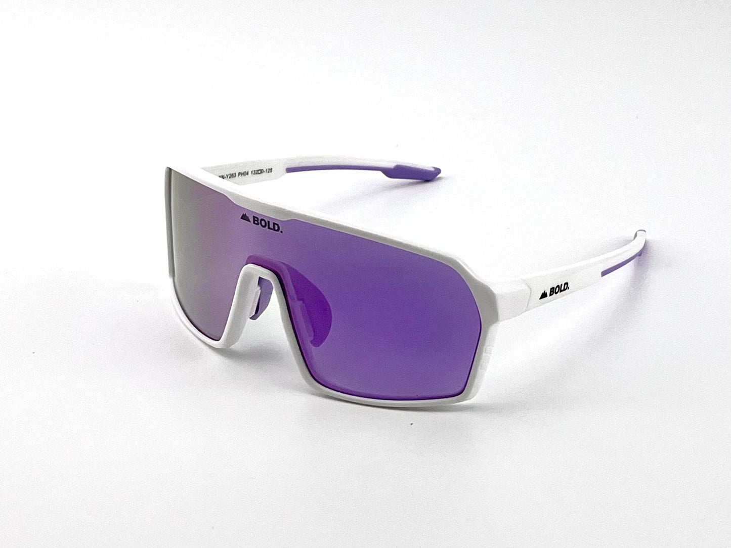 The BOLD Drift Photochromic Sunglasses by boldouterwear feature a white frame, purple-tinted wraparound lenses, and black BOLD. logos on the left lens and temple, showcasing a modern, angular design perfect for MTB, ski, and lifestyle use.