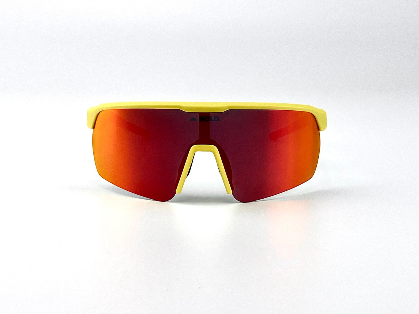 The BOLD Flash Photochromic Sunglasses by boldouterwear feature a yellow frame and large red-orange mirrored lens in a modern, angular design—ideal for MTB, ski, or lifestyle use. Light-adaptive with a visible brand logo on the lens bridge.
