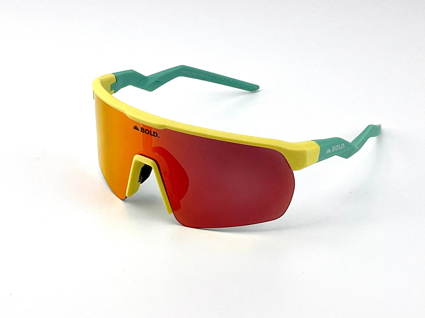 BOLD Flash Photochromic Sunglasses by boldouterwear feature a yellow frame, teal arms, and a large red-orange mirrored lens with the BOLD logo on the upper left. Ideal for MTB, ski, or lifestyle, displayed on a white background.