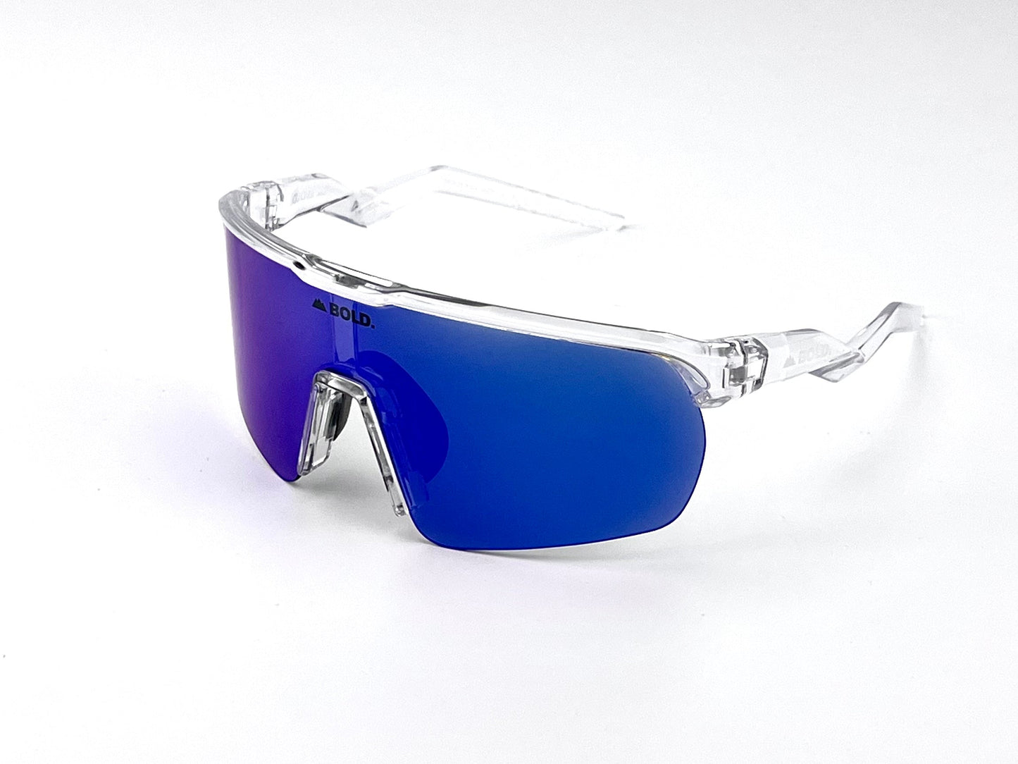 The BOLD Flash Photochromic Sunglasses by boldouterwear feature a clear plastic frame and a single large blue mirrored lens with the brand name in black on the upper left. Perfect for MTB, ski, and lifestyle use. Plain white background.