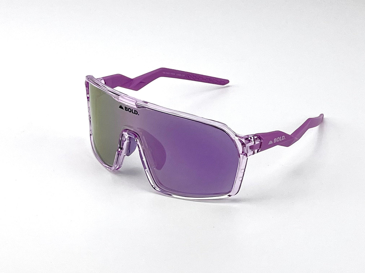 The BOLD Glow Photochromic Sunglasses by boldouterwear feature oversized, purple-tinted non-polarized lenses with transparent purple frames and arms, plus “BOLD.” printed on lens and side—a modern, sporty eyewear choice for MTB, ski & lifestyle.