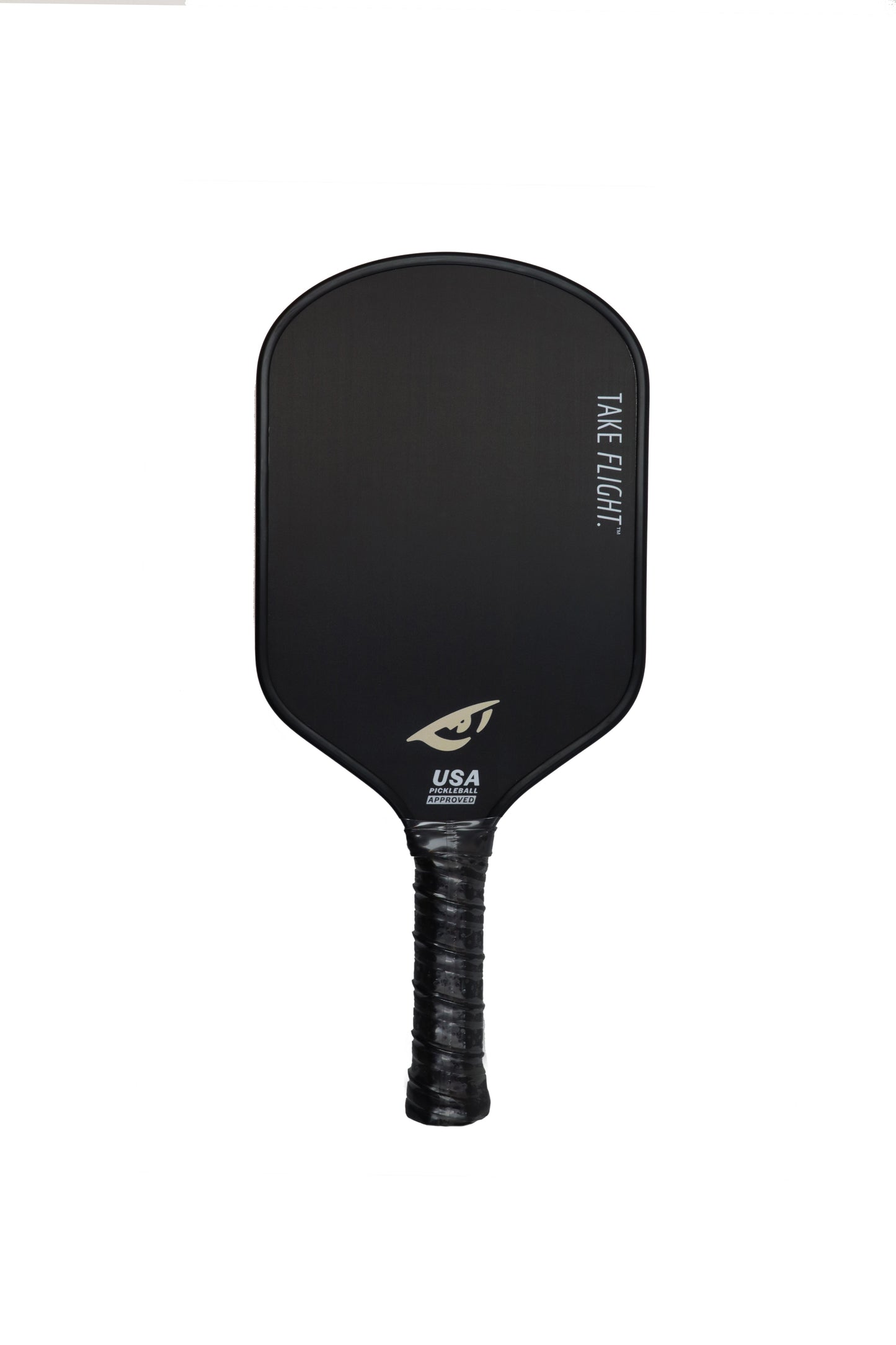 The El Capitán 1.0 by KONDOR PICKLEBALL is a black raw carbon paddle with an extended energy grip, featuring "TAKE FLIGHT." in white at the top right and a gold eye logo above "USA Pickleball Approved" near the handle, shown on a plain white background.