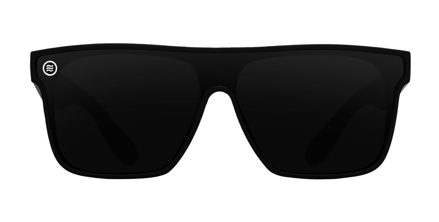 The Neven Eyewear Bold XL sunglasses feature oversized black rectangular frames, dark UV-protective lenses, and a small silver circular logo with wave lines on the top left of the left lens. Shown against a white background.