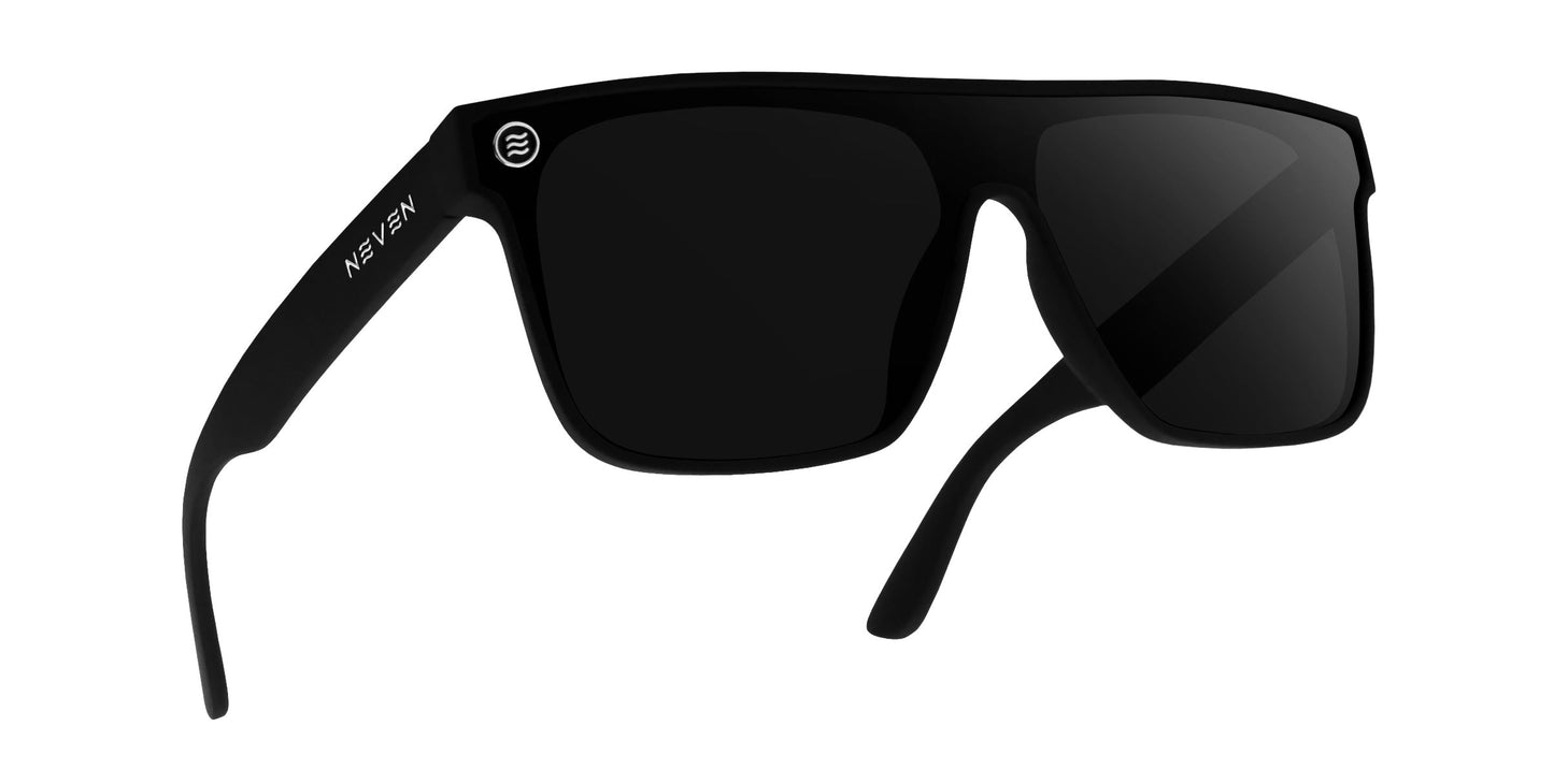 A pair of Bold XL matte black rectangular oversized sunglasses by Neven Eyewear with dark polarized lenses, slightly curved arms, and a round white logo near the hinge. “Neven” is printed in white on the left temple. Shown on a plain white background.