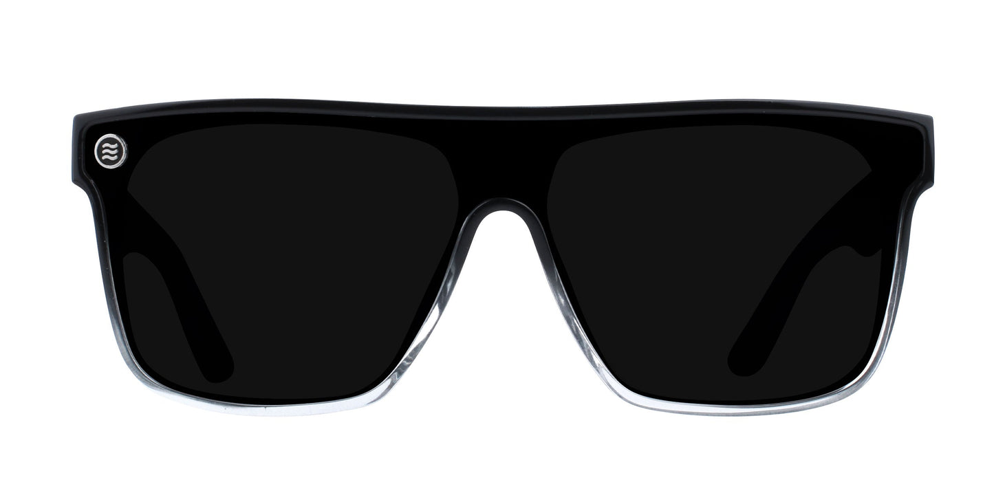 A pair of black oversized "Jordan" sunglasses by Neven Eyewear, featuring thick glossy rectangular frames with rounded edges, a small circular logo on the top left corner, dark UV400 lenses, and bold styling.