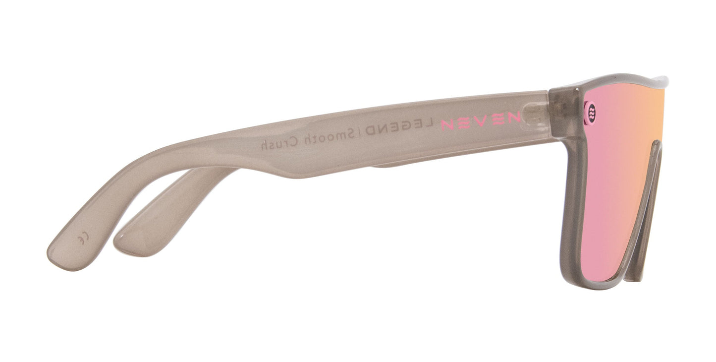 Side view of Neven Eyewear’s Smooth Crush sunglasses in beige pink featuring thick semi-transparent arms, reflective pink-tinted impact-resistant UV400 lens, and “LEGEND Smooth Crush” plus “NEVEN” in pink on the inner arm. Slightly squared frame.