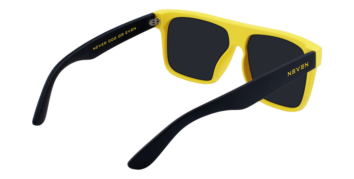 The Swarm by Neven Eyewear: yellow shades with black arms, seen from back and side. “NEVER ODD OR EVEN” in gold on the inner left arm, “NEVEN” on the outer right. Polarized lenses offer UV400 protection with a dark rectangular look.
