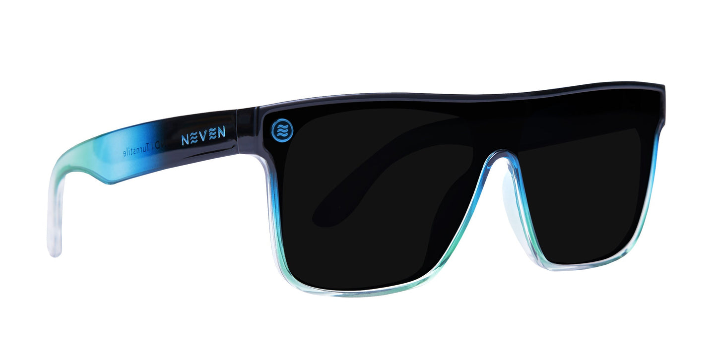 The Neven Eyewear Turnstile sunglasses feature rectangular polarized black lenses and a glossy gradient frame blending blue to light green. “NEVEN” in white and a wave icon are on the left arm. Plain white background.