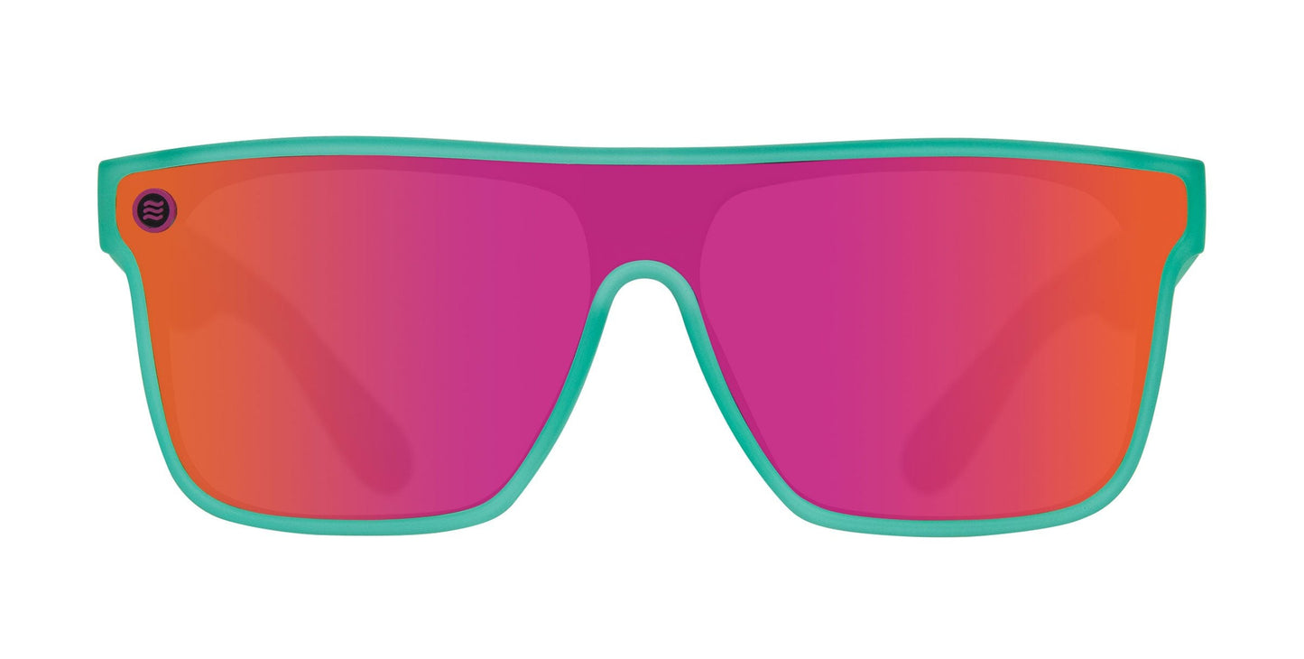 Neven Eyewear’s X sunglasses from the Legend collection feature bold teal rectangular frames, large pink-to-orange gradient reflective lenses with UV400 protection, rounded top corners, and a small circular logo on the left lens. White background.