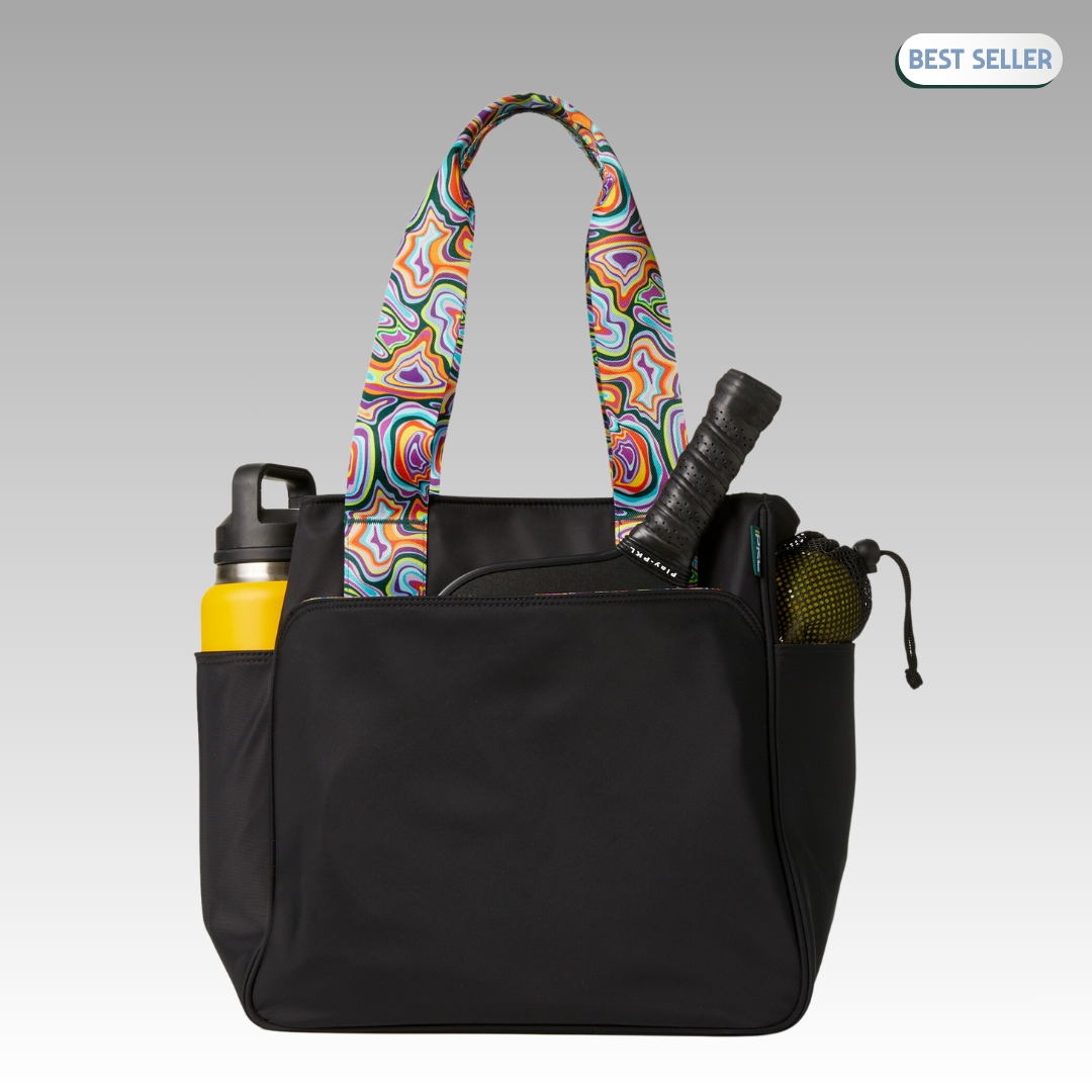 The Lulu Pickleball Tote by Playly Store is shown on a gray background with colorful patterned handles. A yellow water bottle, tennis racket, and ball are in the side pockets. A “Best Seller” label appears in the top right corner.