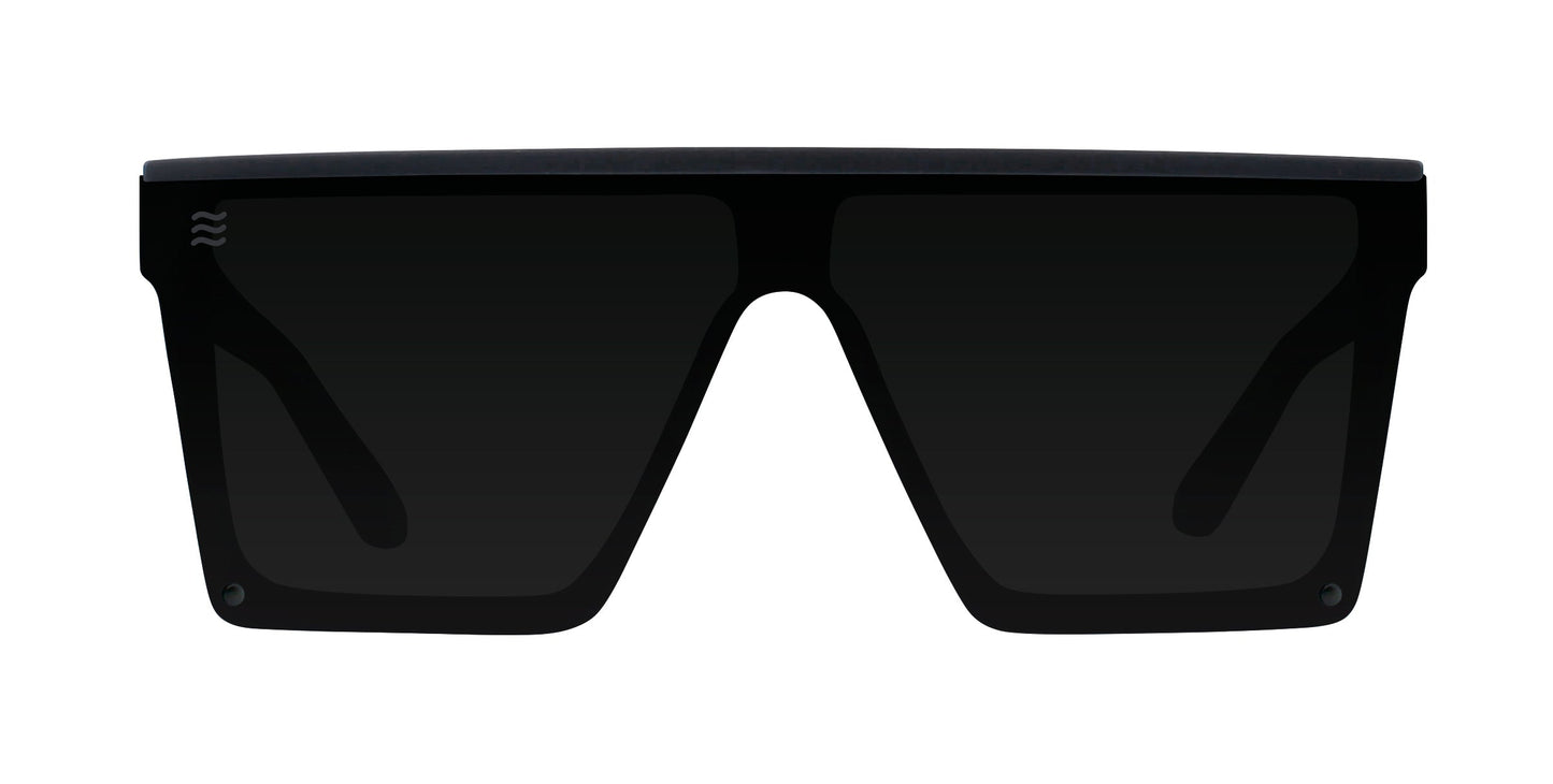 The IWMSAN by Neven Eyewear are rectangular, oversized black polarized sunglasses with a flat top frame and dark impact-resistant lenses. Subtle branding appears on the top left corner of the left lens. Shown front-facing on a white background.