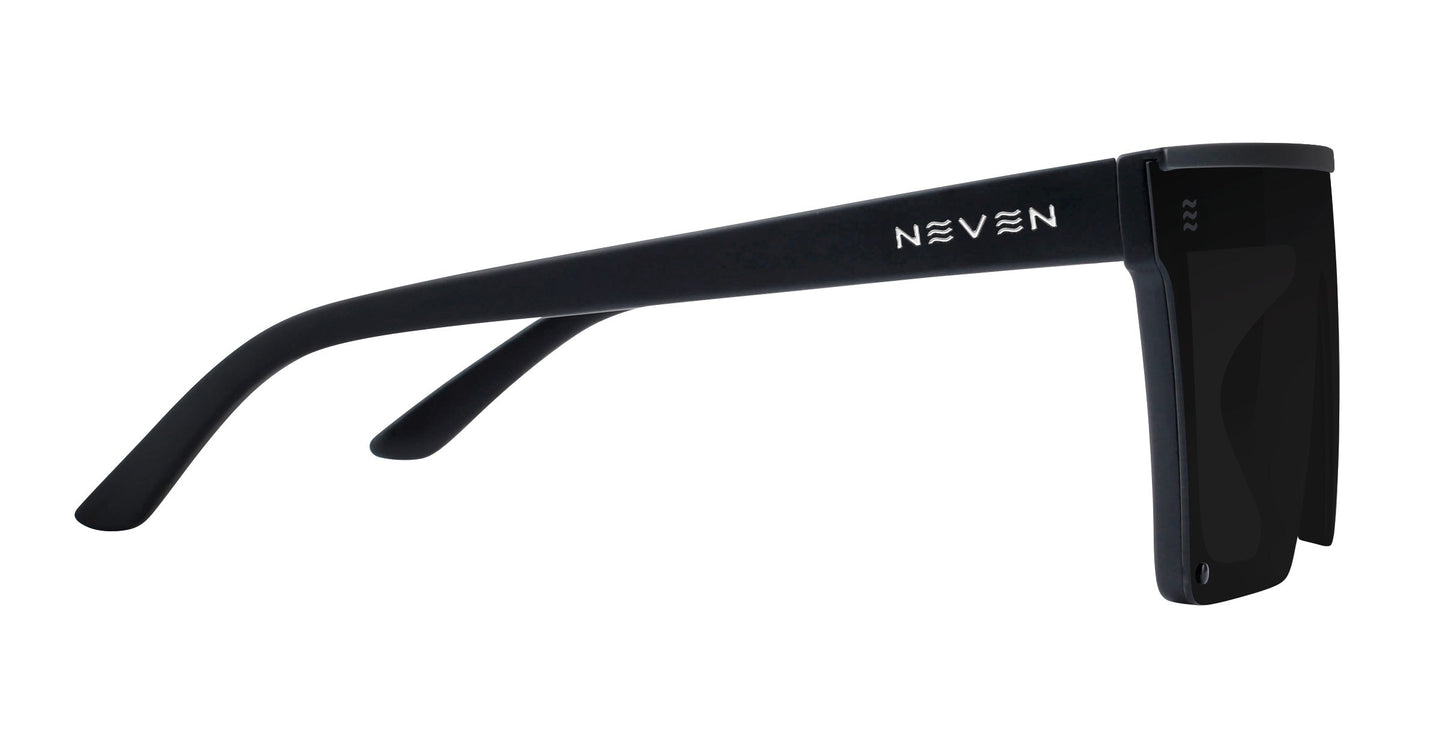 The IWMSAN by Neven Eyewear are black, rectangular polarized sunglasses with thick frames, wide temples, and NEVEN in white on the left temple. The flat dark lenses provide UV400 protection for a sleek, futuristic look.