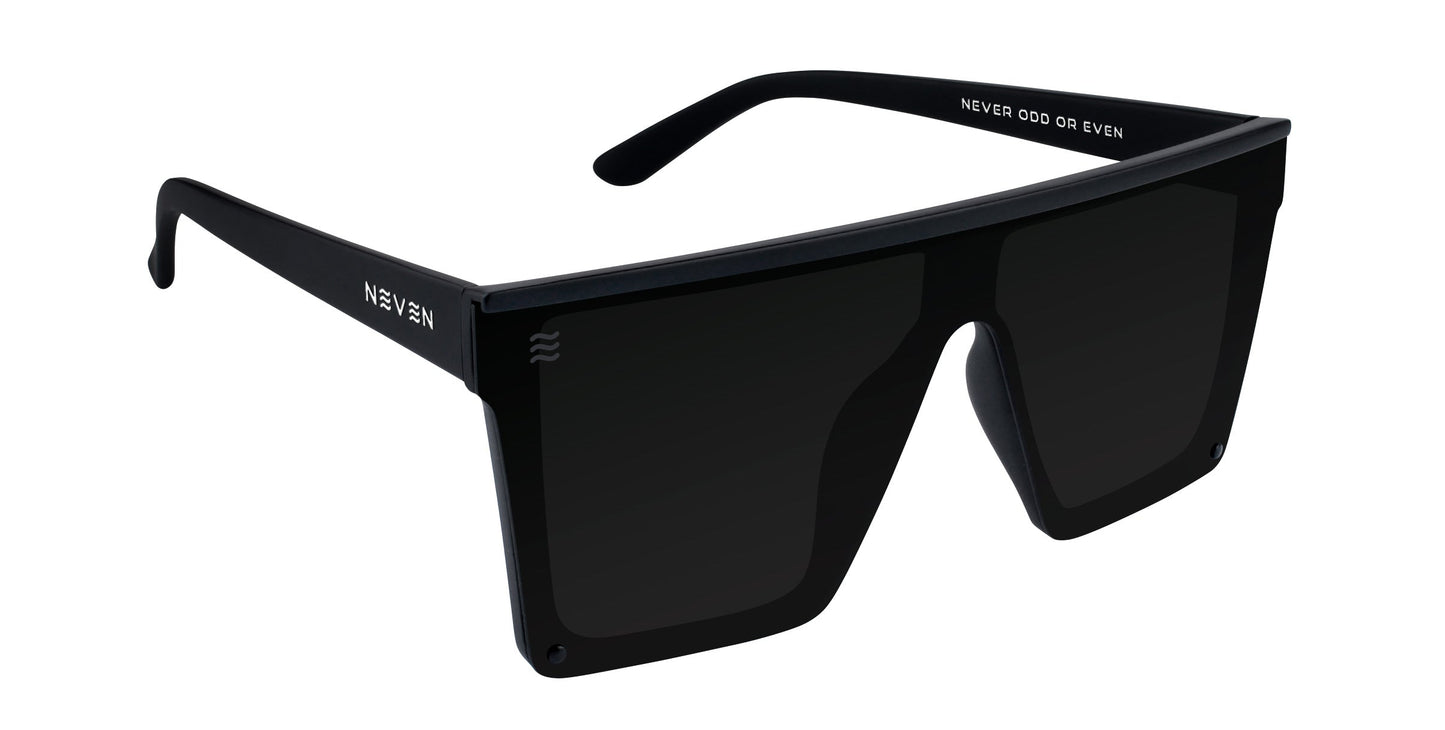 IWMSAN by Neven Eyewear: black, oversized rectangular polarized sunglasses with a bold flat top. Left arm reads NEVEN, right NEVER ODD OR EVEN in white. UV400 protection and impact-resistant lenses combine style and safety.