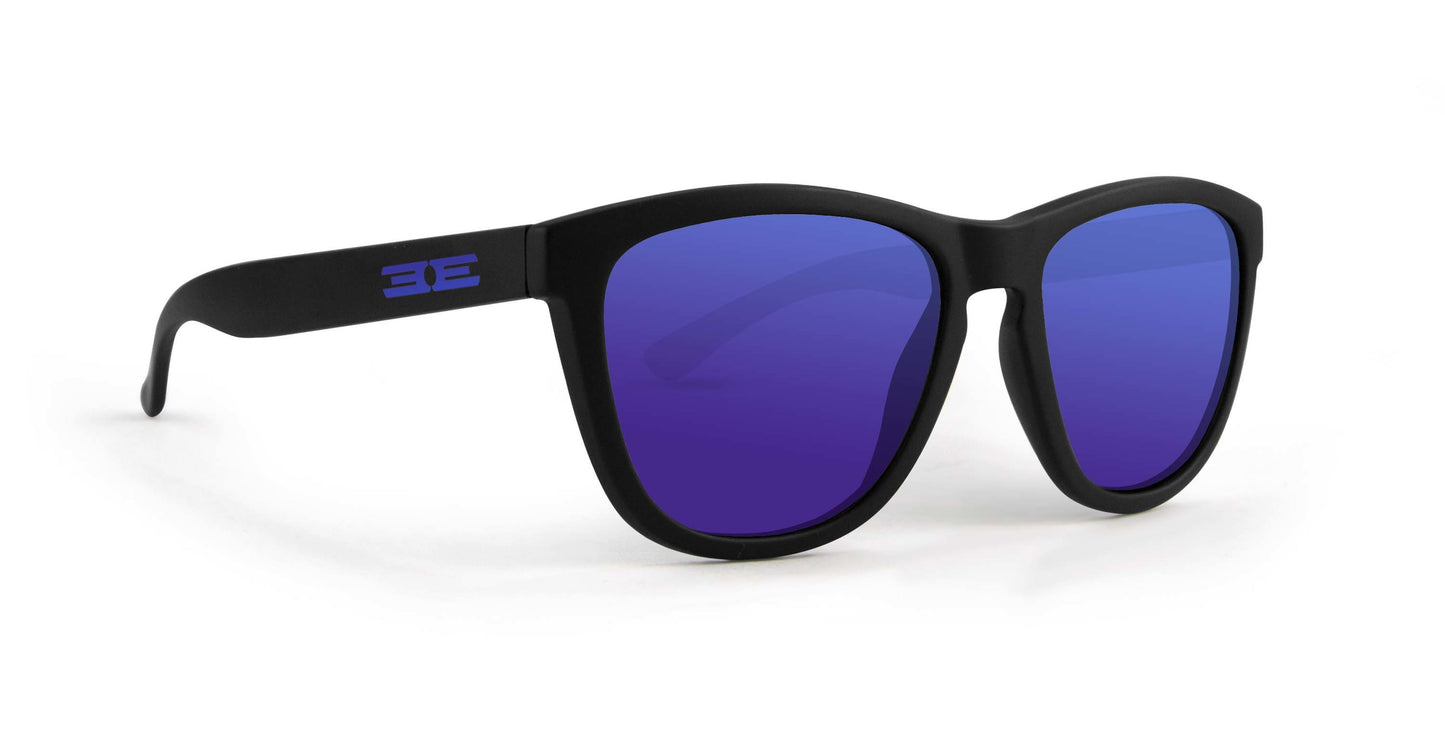 A pair of Epoch Eyewear VIBE sunglasses with black frames and large, dark blue rounded square lenses. The left arm displays a purple stylized EE logo. These luxury sunglasses are angled left on a white background.