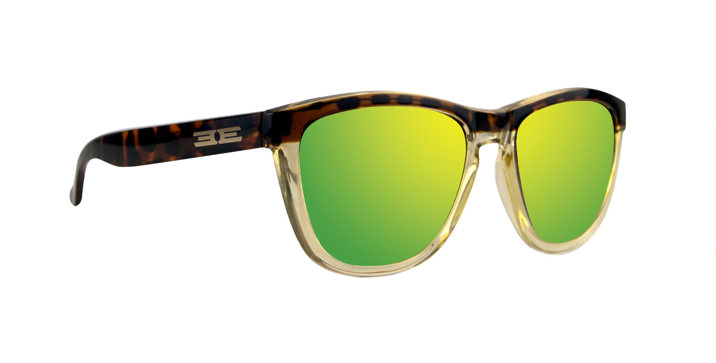Epoch Eyewear’s VIBE sunglasses feature green mirrored lenses, clear lower rims, and brown tortoiseshell upper rims and arms with a white stylized logo on the temple—luxury style showcased against a plain white background.