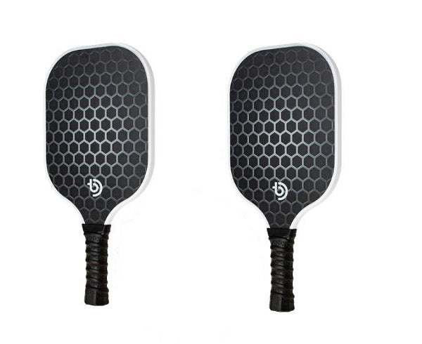 The Big Dink - Model1 Paddle 2-pack Special displays two lightweight black carbon fiber paddles with honeycomb-patterned faces, white edges, textured black grips, and a small white The Big Dink logo near the handle on a white background.
