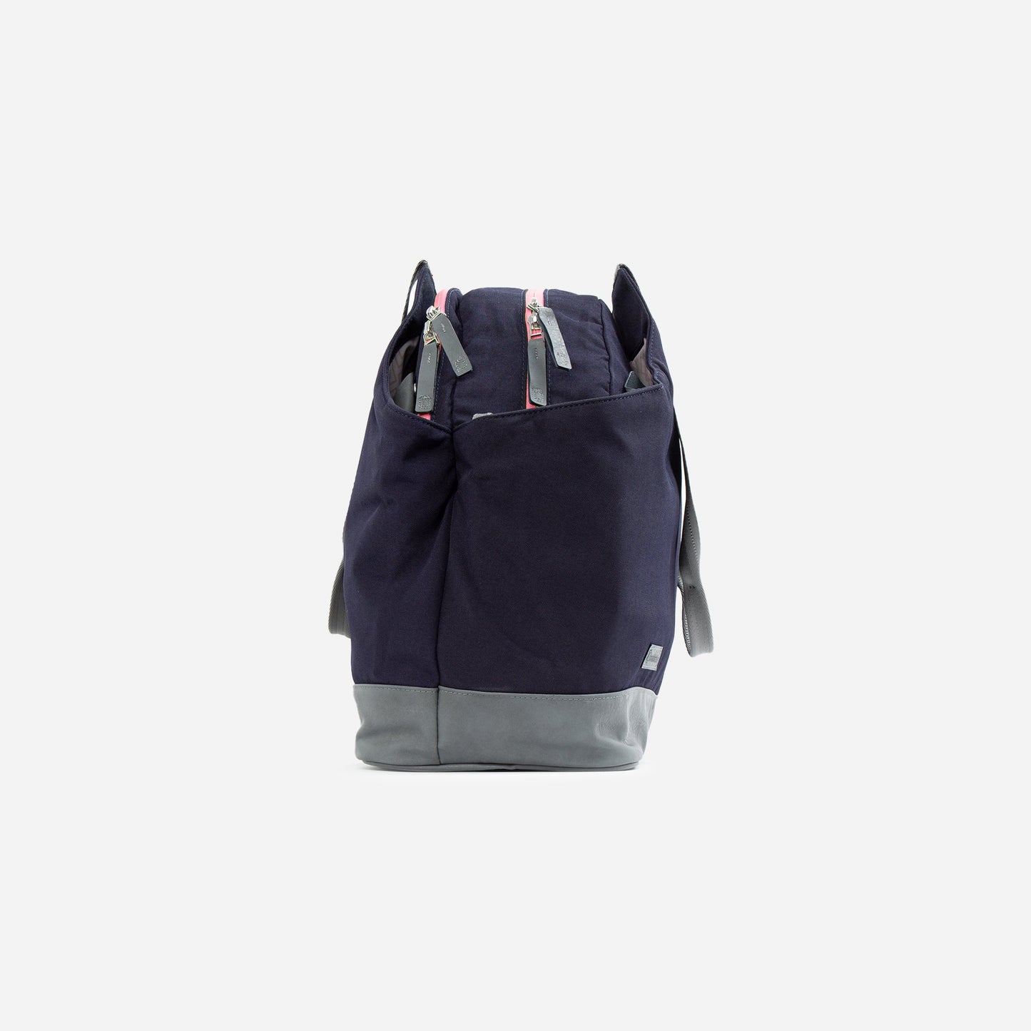 The Doubletake LONDON Pickleball Duffel & Tote in navy with a gray bottom stands upright against a white background, featuring two front zippered pockets, gray side handles, and zipper pulls accented with small red details.