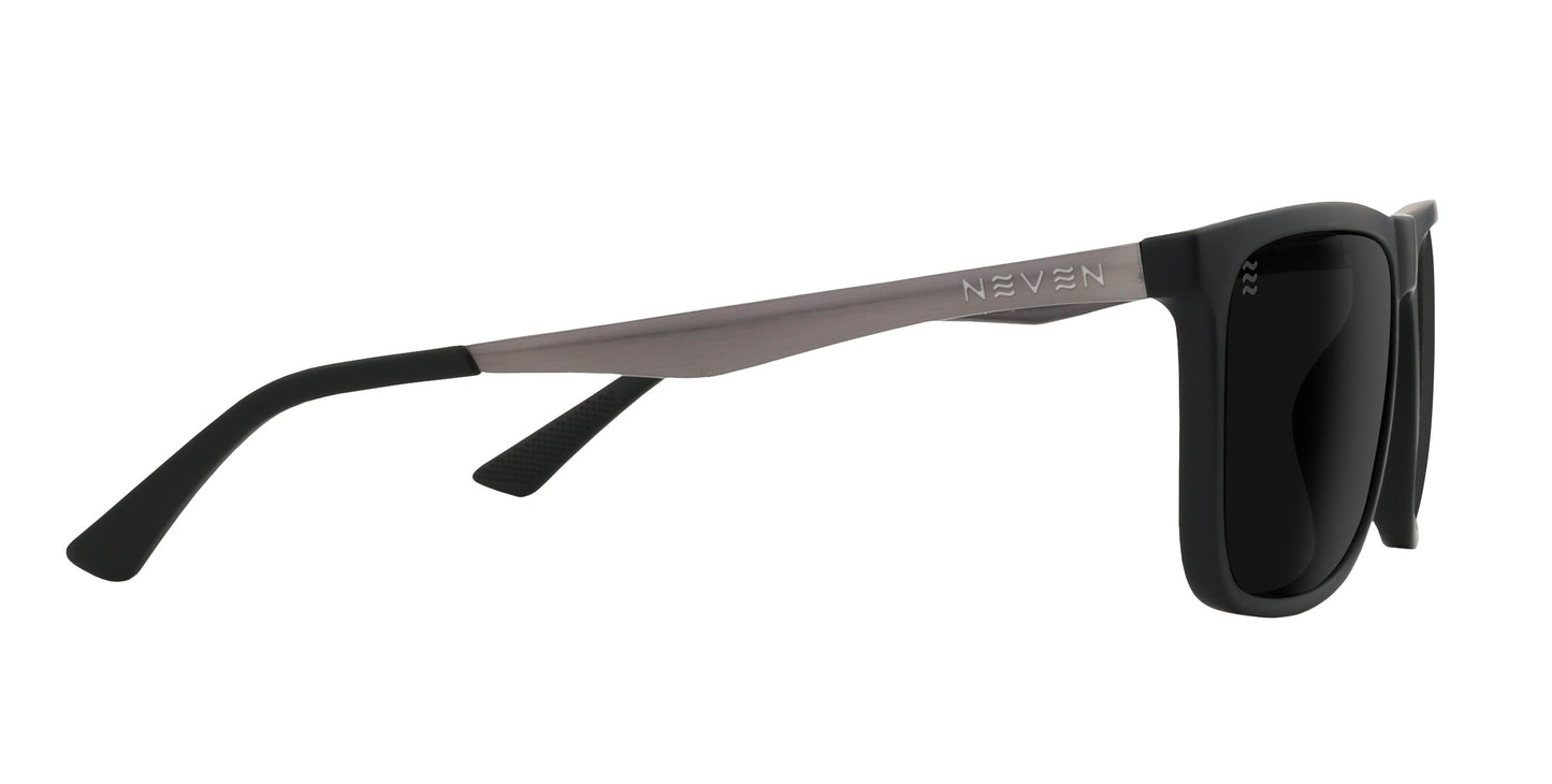 A pair of Blueprint sunglasses by Neven Eyewear shown from the side features a glossy black rectangular front, matte gray arms with black tips, engraved branding, and polarized dark lenses for excellent UV protection.