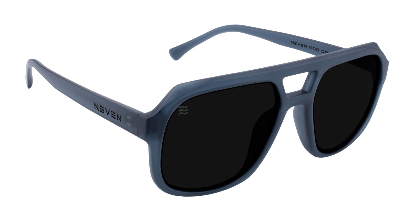 The Koa aviator sunglasses by Neven Eyewear feature a matte gray frame, large polarized UV400 lenses, bold lines, a double bridge design, and curved temples. "NEVEN" is printed on the left arm.