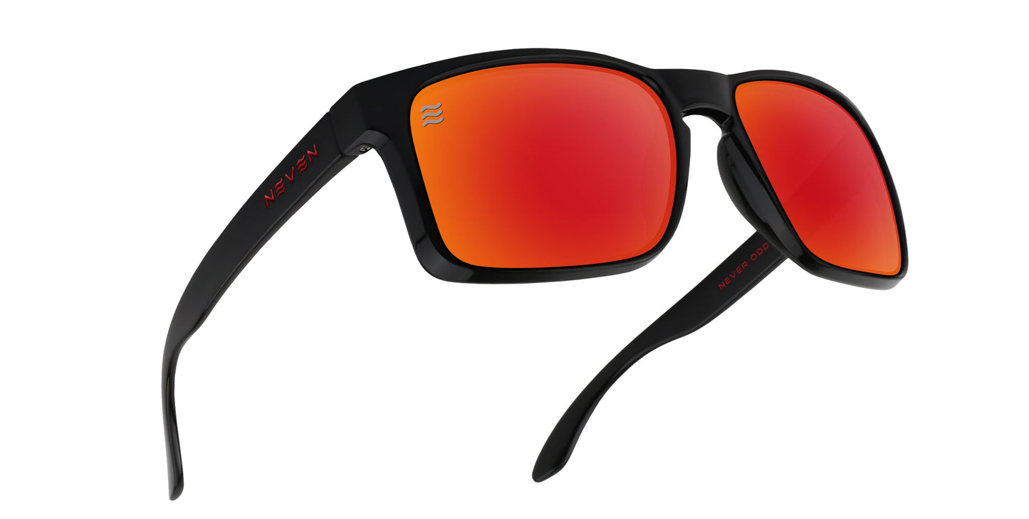 The John Wayne XL by Neven Eyewear are black sunglasses with thick frames and red-orange mirrored lenses. Oversized and polarized with UV400 protection, they feature "Neven" in red on the right temple and a white wave logo on the left lens.