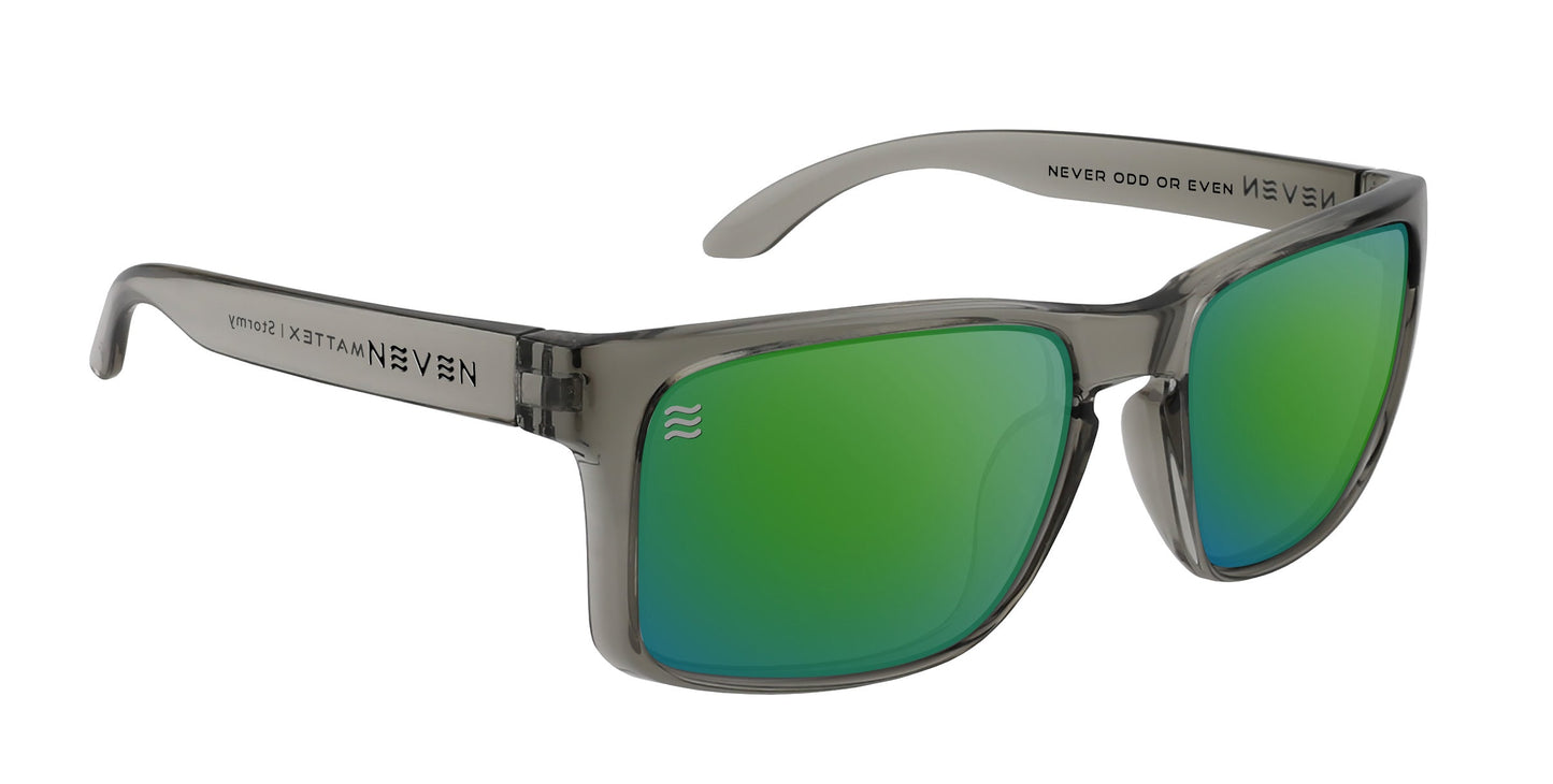 Stormy by Neven Eyewear: gray semi-transparent TR90 sunglasses with reflective green, impact-resistant polarized UV400 lenses. "NEVER ODD OR EVEN" is printed inside the right arm; left shows TITAN, NEVEN (mirrored), and a double-wave logo.
