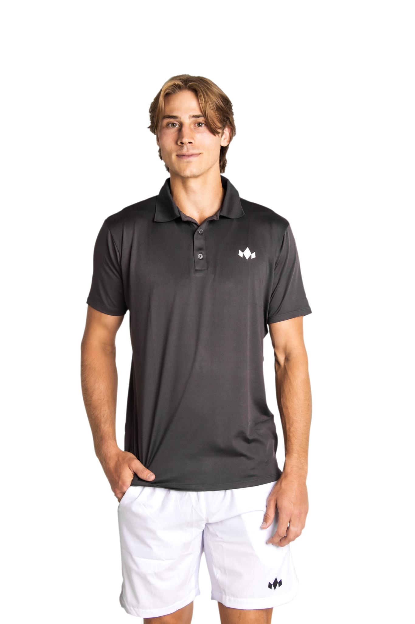 A young man with light brown, medium-length hair stands against a white background, wearing Diadem Sports Men's Essential Everyday Tops and white athletic shorts from our on-court collection, featuring a small white logo.