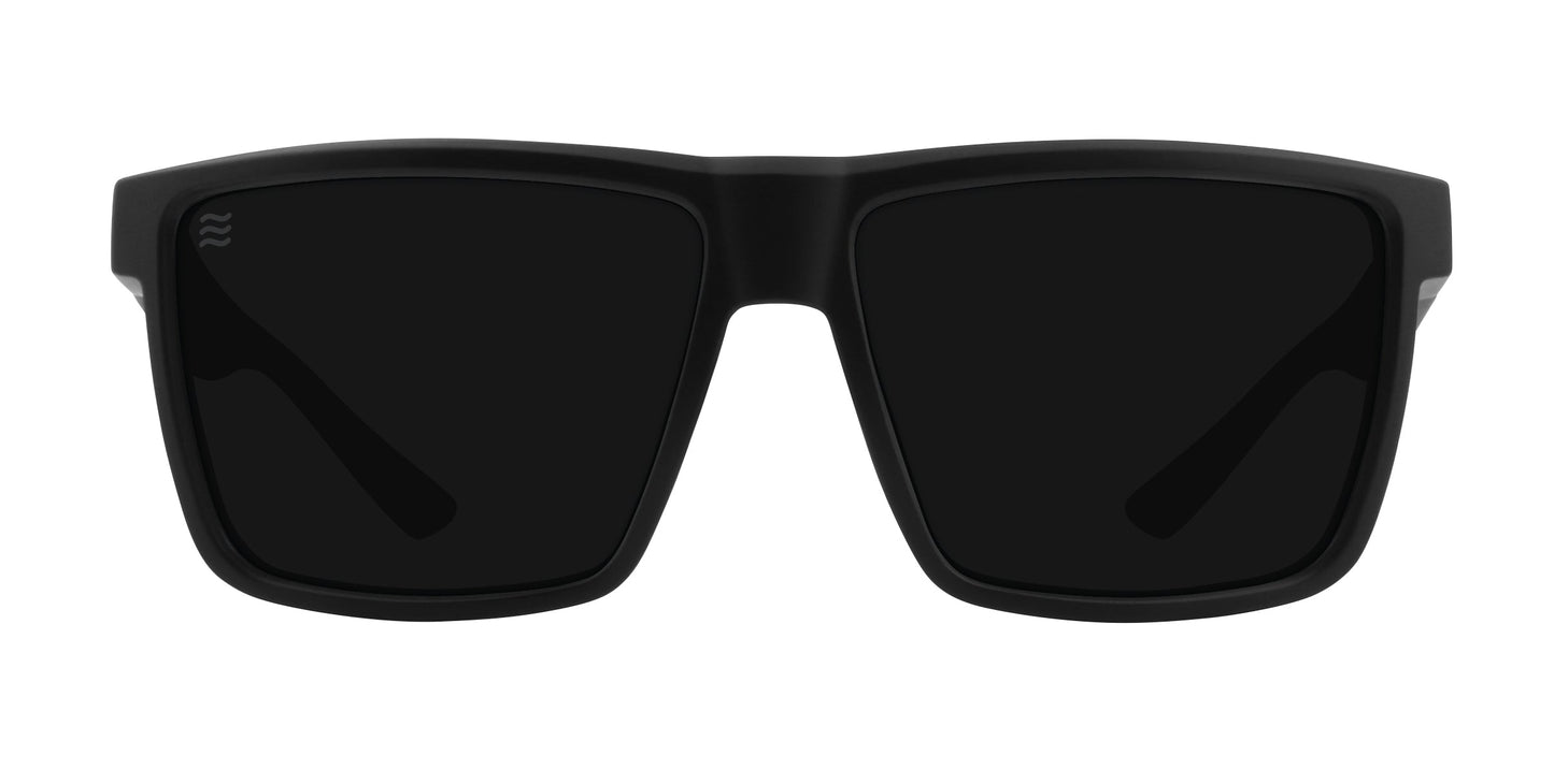 A front view of Honey Hole by Neven Eyewear—black square sunglasses with thick frames, dark lenses, and a small wavy logo on the left lens. These shades offer polarized UV400 protection and are shown on a white background.