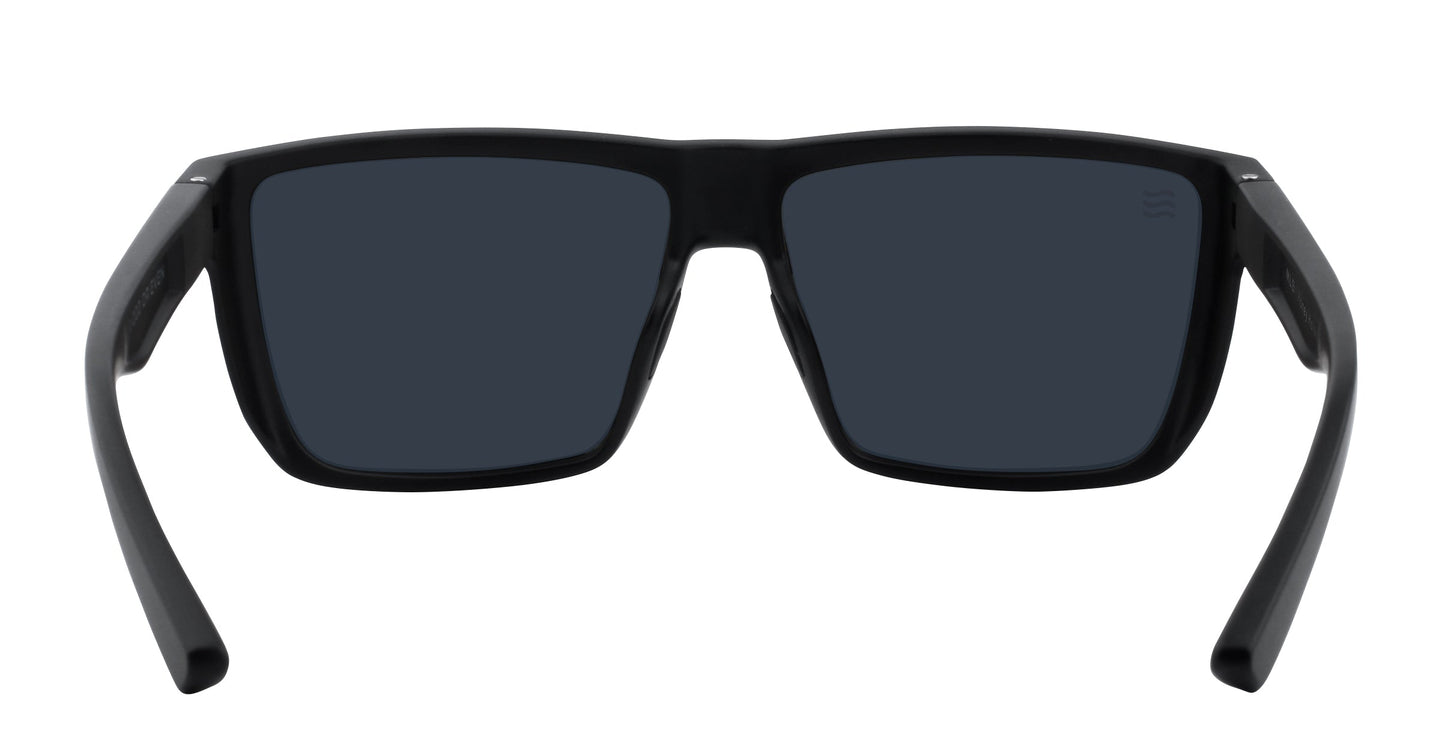A pair of Neven Eyewear Honey Hole sunglasses is displayed from the back, featuring thick matte black frames, dark polarized UV400 lenses, and slightly angled arms. The bold, modern design stands out against a plain white background.