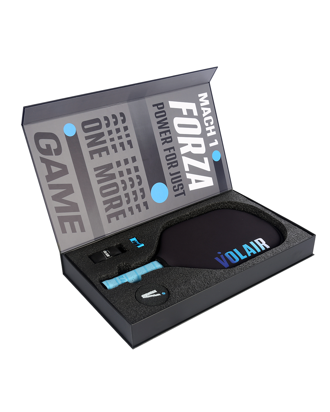 The Volair Pickleball Mach 1 Forza Pickleball Paddle comes in a black gift box with foam cutouts, a blue overgrip, and tool. The lid reads “MACH 1 FORZA POWER FOR JUST ONE MORE GAME.” Money Back Guarantee included.