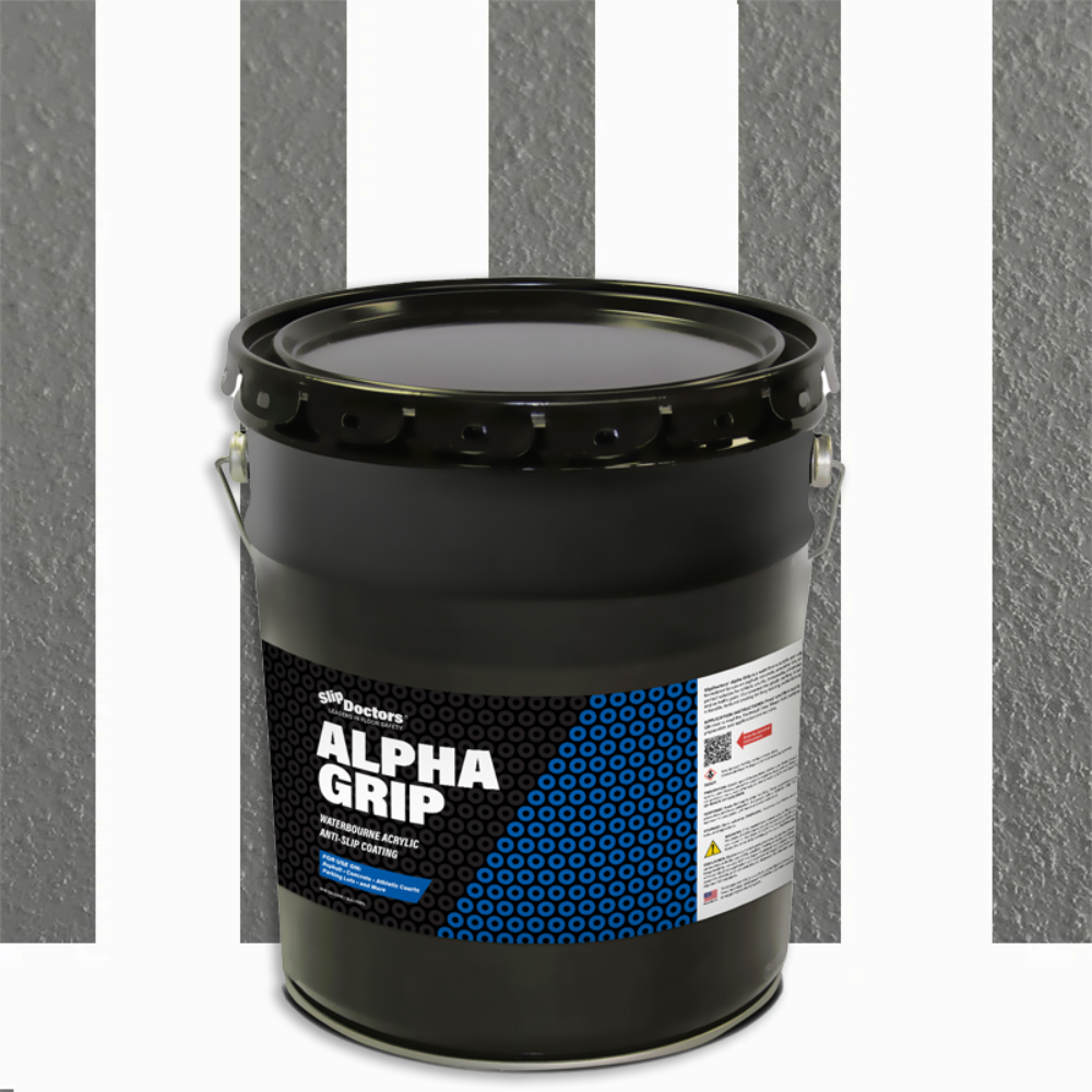 A large black bucket of SlipDoctors Alpha Grip Non-Slip Stripe and Athletic Court Paint with a blue and black patterned label, metal handle, and lid sits before a textured gray surface featuring three vertical white stripes.